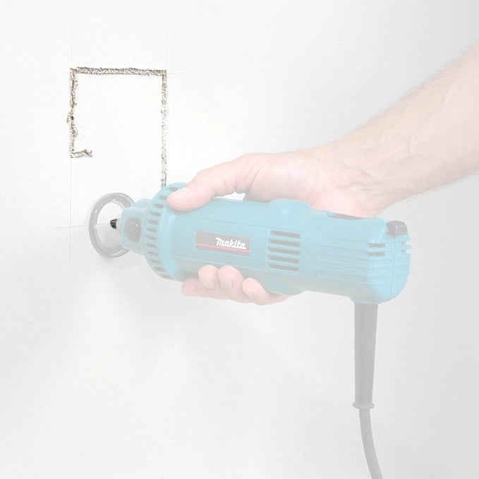 Makita 1/8" drywall guide tip bit cutting through drywall for clean and controlled results
