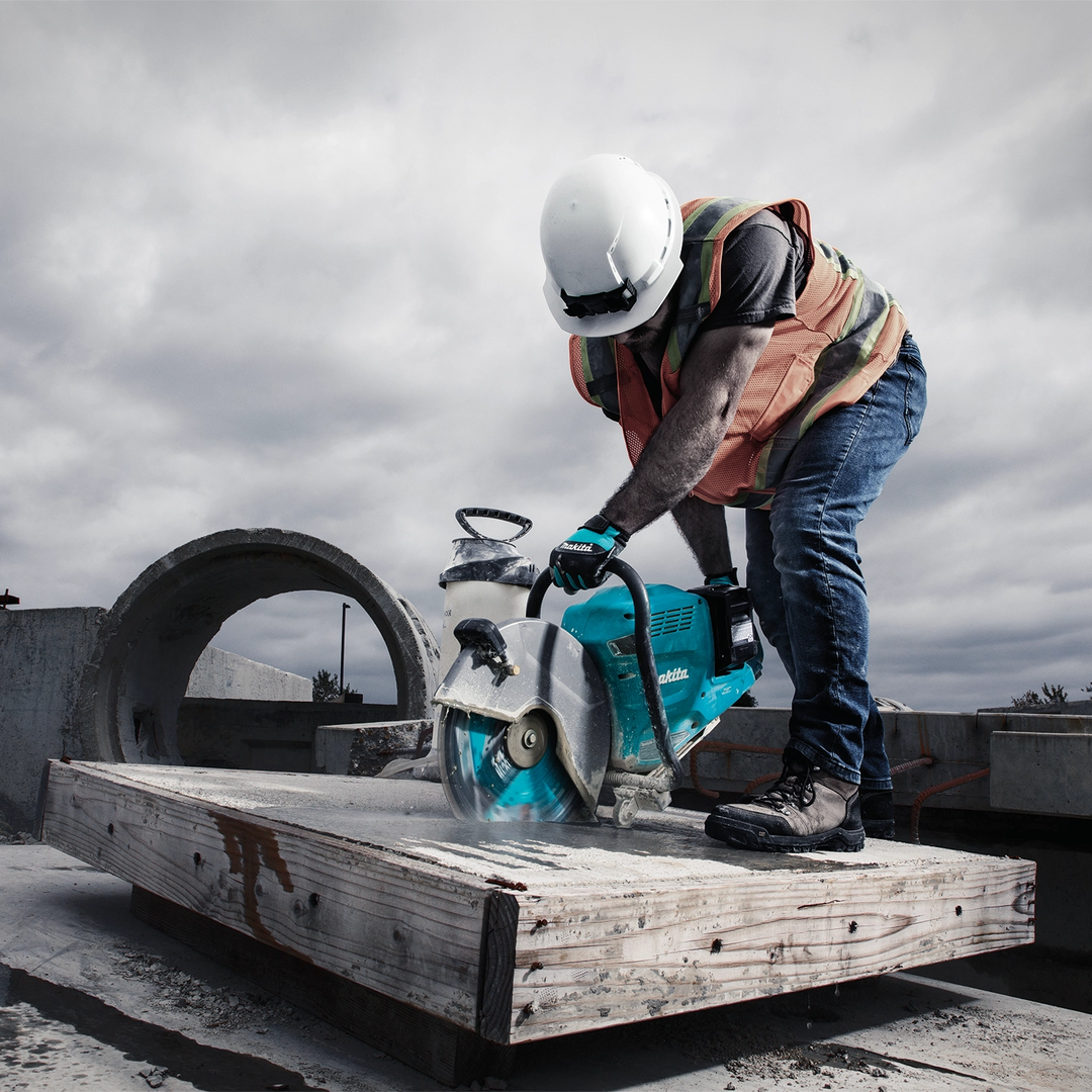 Makita segmented diamond blade actively cutting concrete using a power cutter

