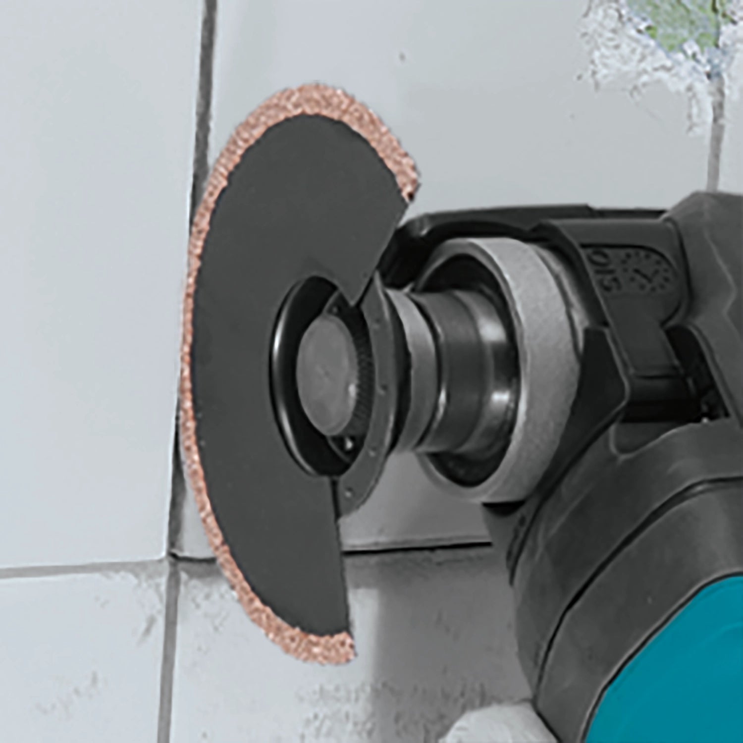 makita starlock grout blade in use removing grout between tiles with oscillating multi tool
