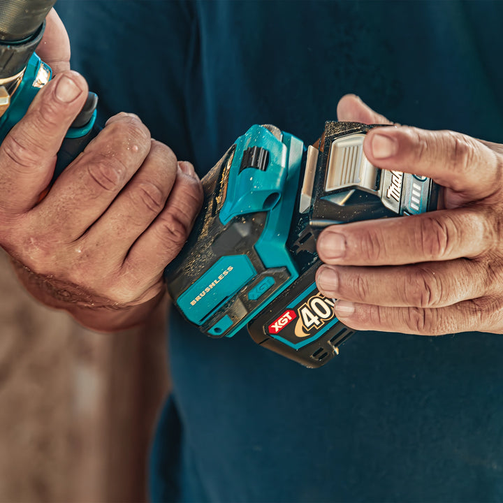 connecting makita 40v xgt battery to gph01 drill showing insertion process
