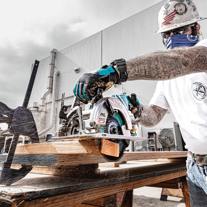 makita circular saw in action cutting subflooring with battery inserted
