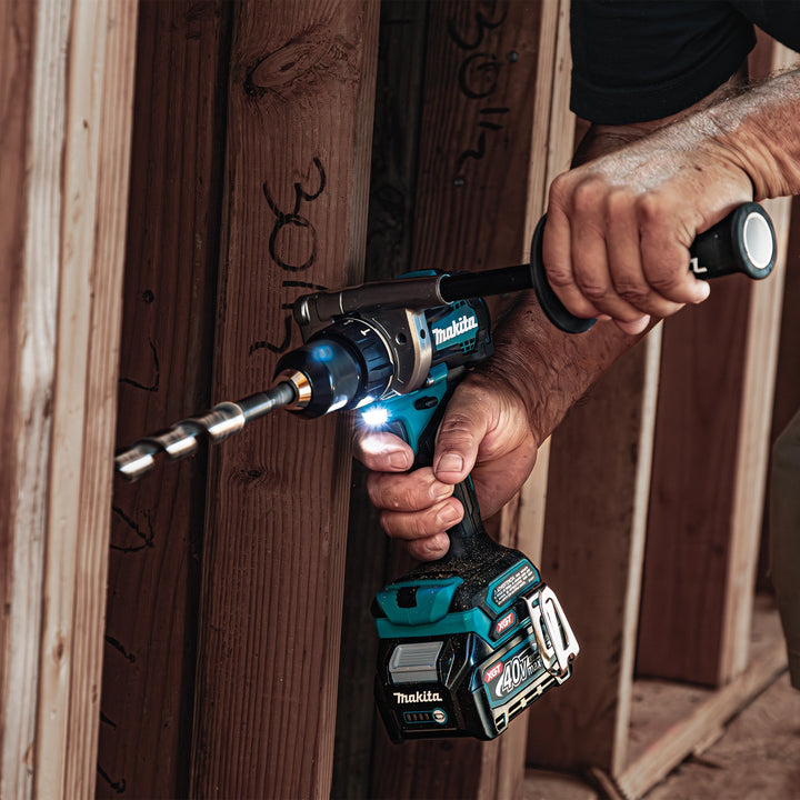active use of makita 40v tools on job site platform with workers in background

