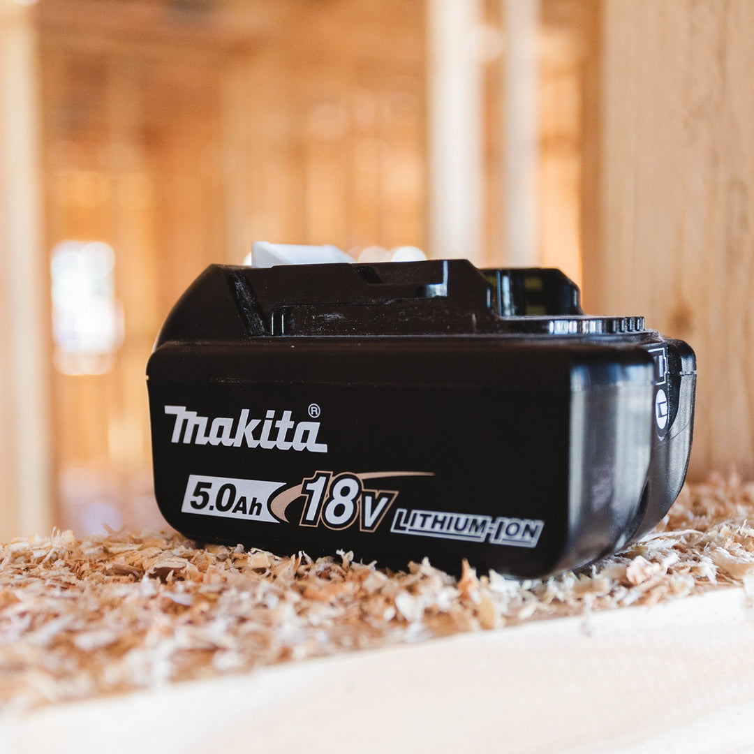 Makita 18V 5.0Ah battery installed in cordless tool on active job site
