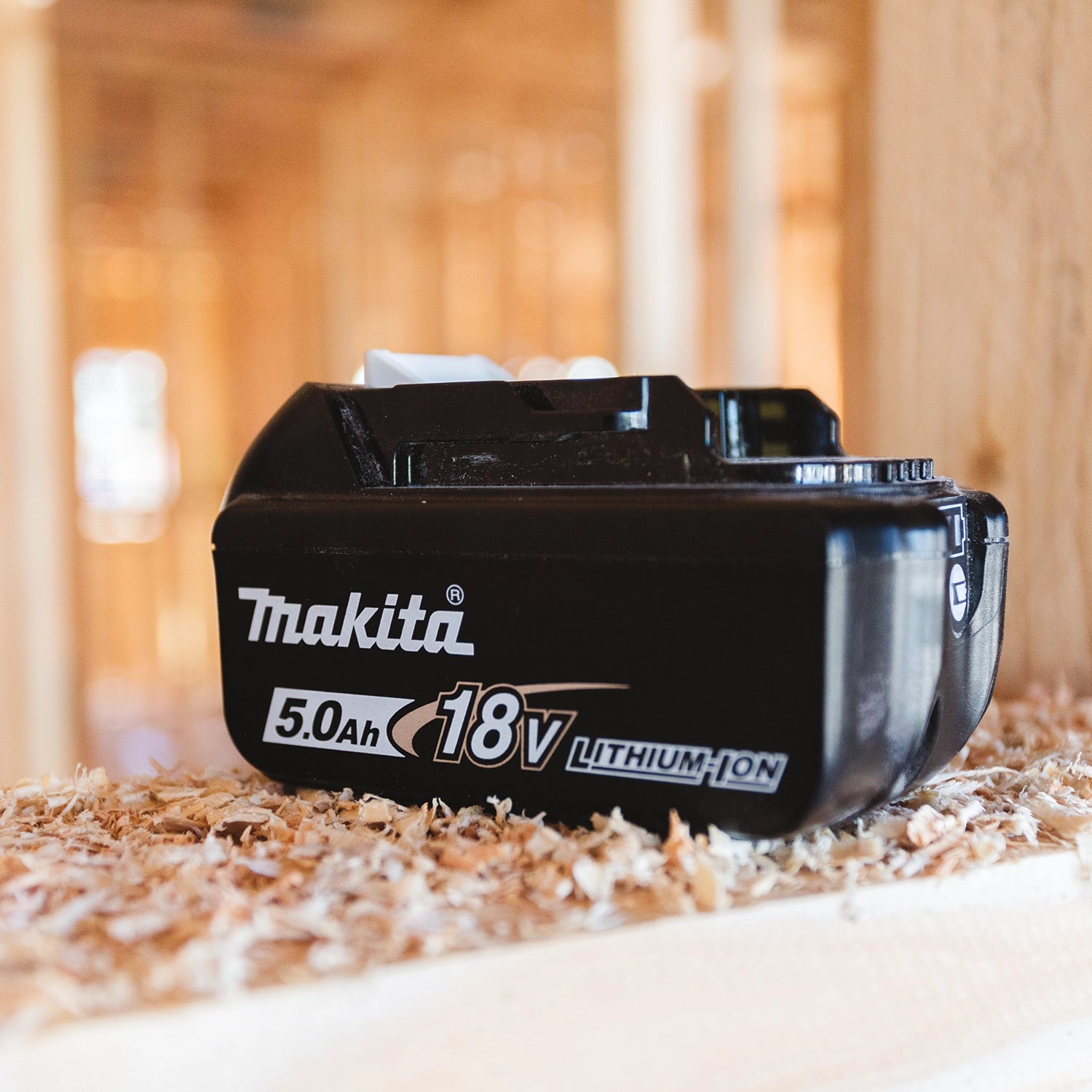 Makita 18V 5.0Ah battery installed in cordless tool on active job site
