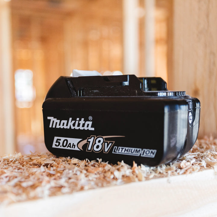 Makita 18V 5.0Ah battery installed in cordless tool on active job site
