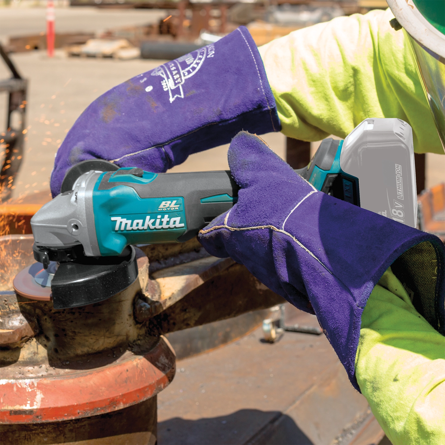 Makita grinder cutting through rebar in use on job site

