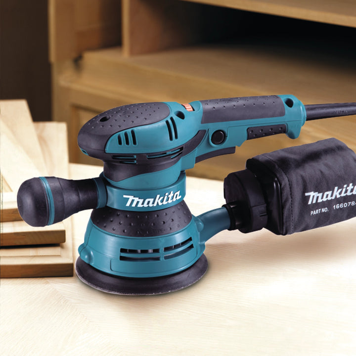 close-up of makita orbit sander on jobsite sanding wood with precision
