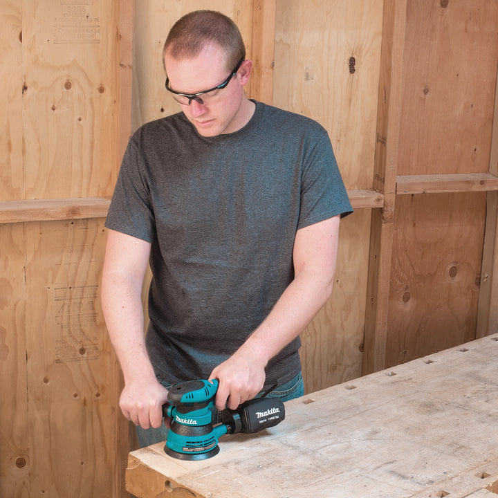 makita random orbit sander being used on surface showing real-world application
