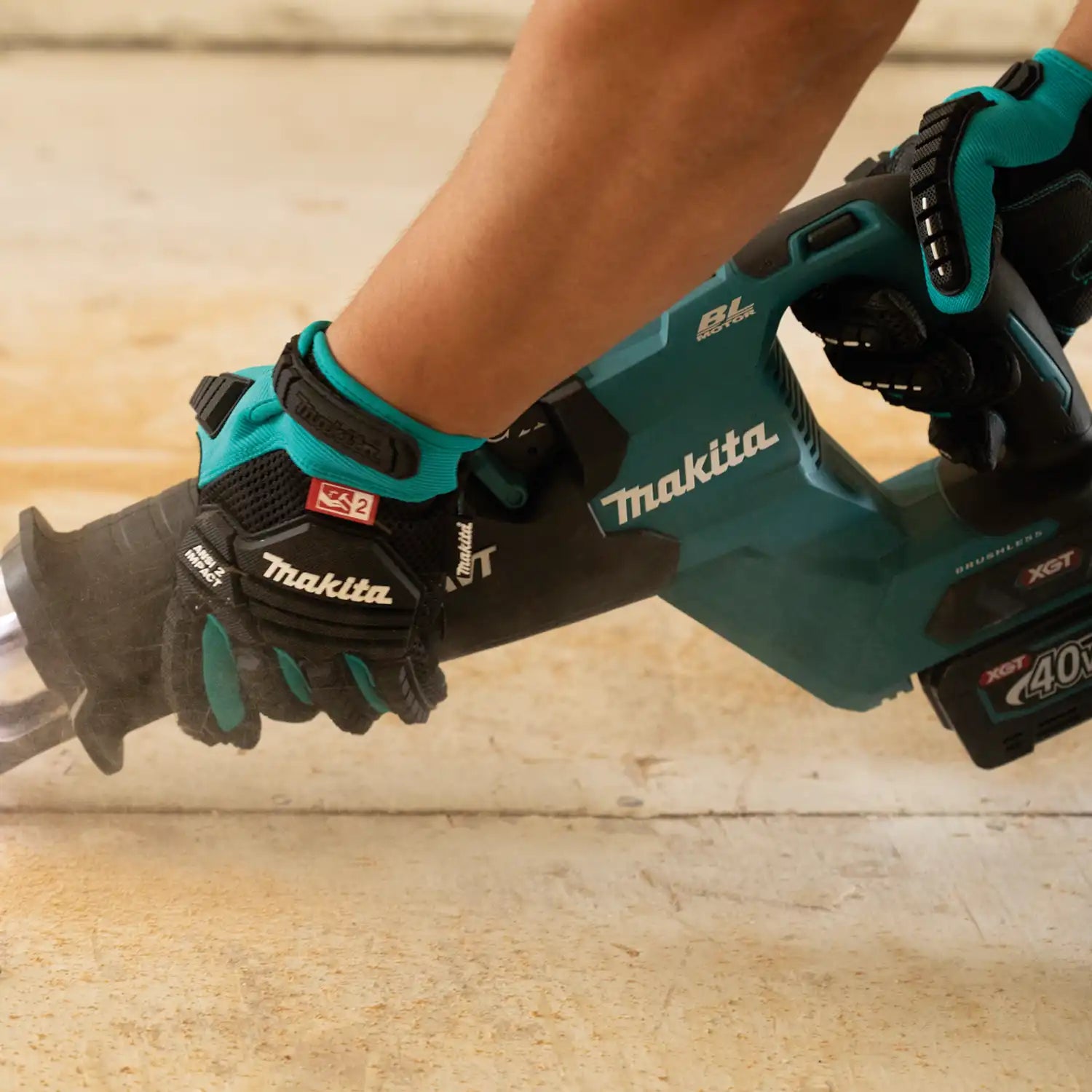 Gloved worker using a power tool while wearing Makita impact-rated demolition gloves

