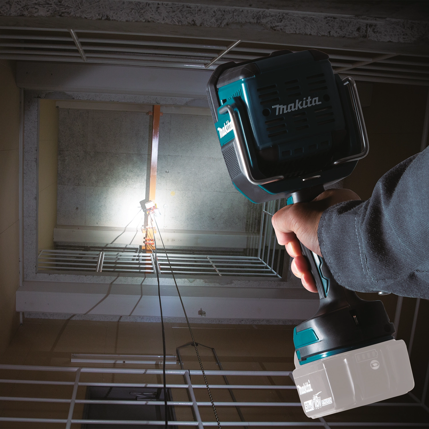 Makita DML812 being used on dark jobsite
