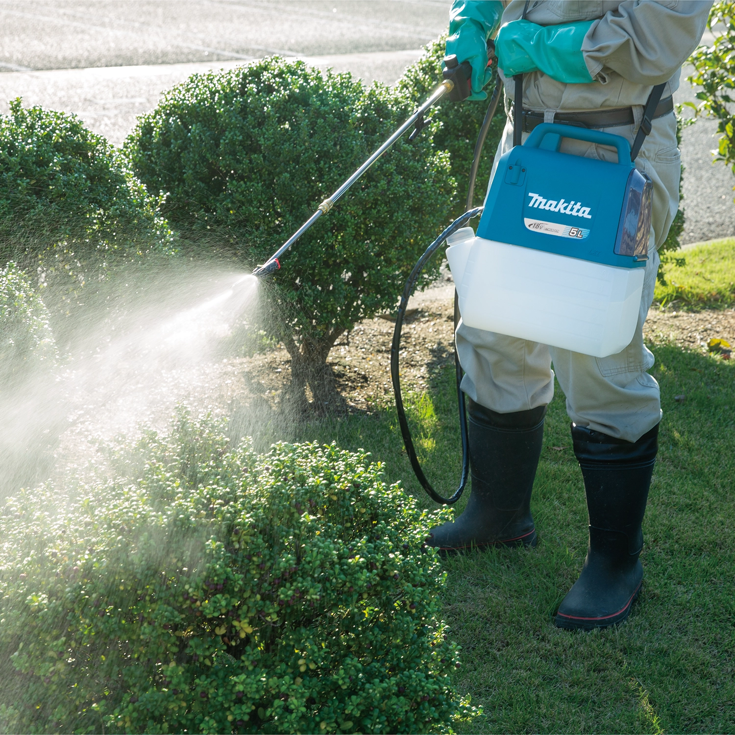 Sprayer being used to treat garden plants on a residential property
