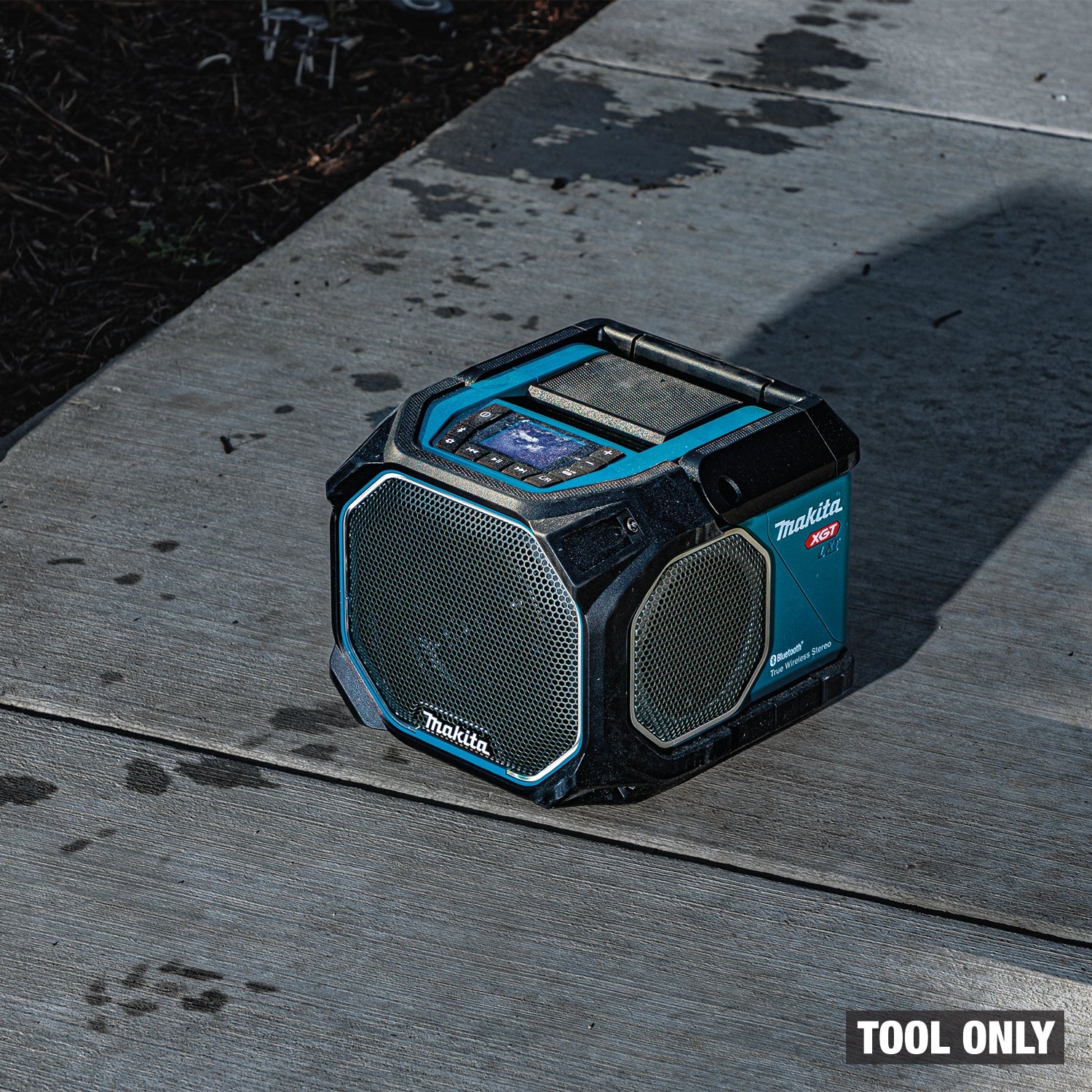 Makita GRM05 Bluetooth speaker placed on top of jobsite work surface
