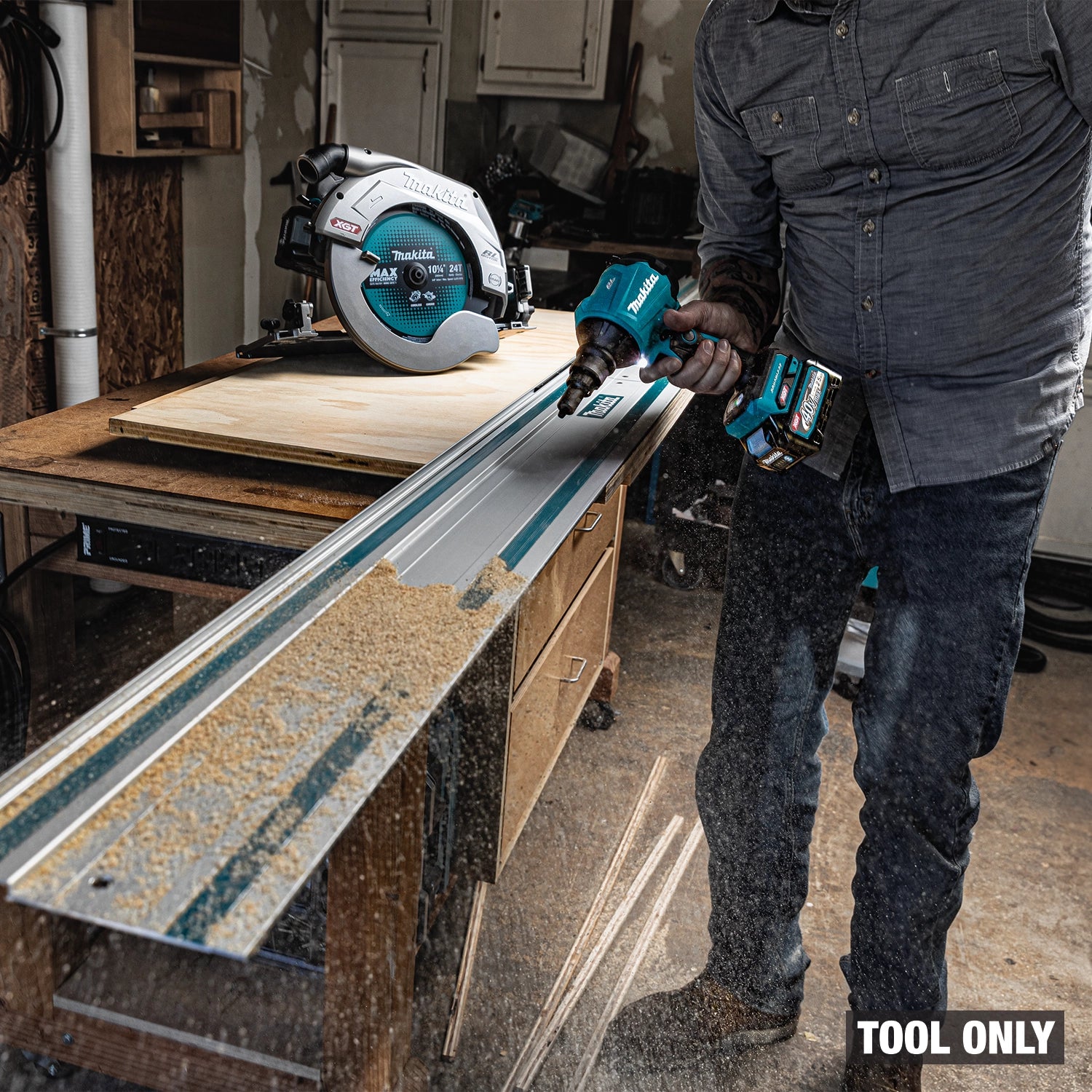 Makita dust blower in use clearing sawdust buildup
