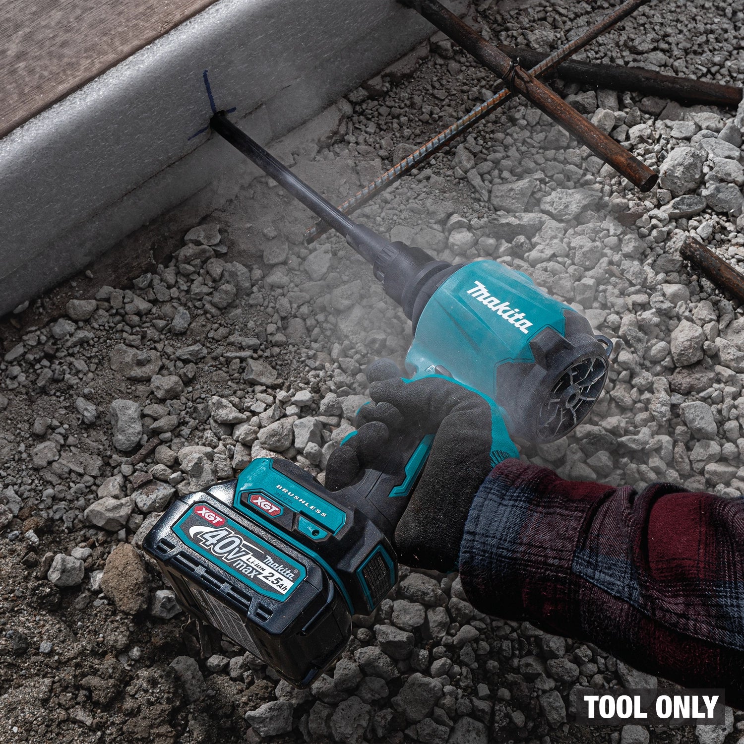Makita blower blowing visible dust and debris into air
