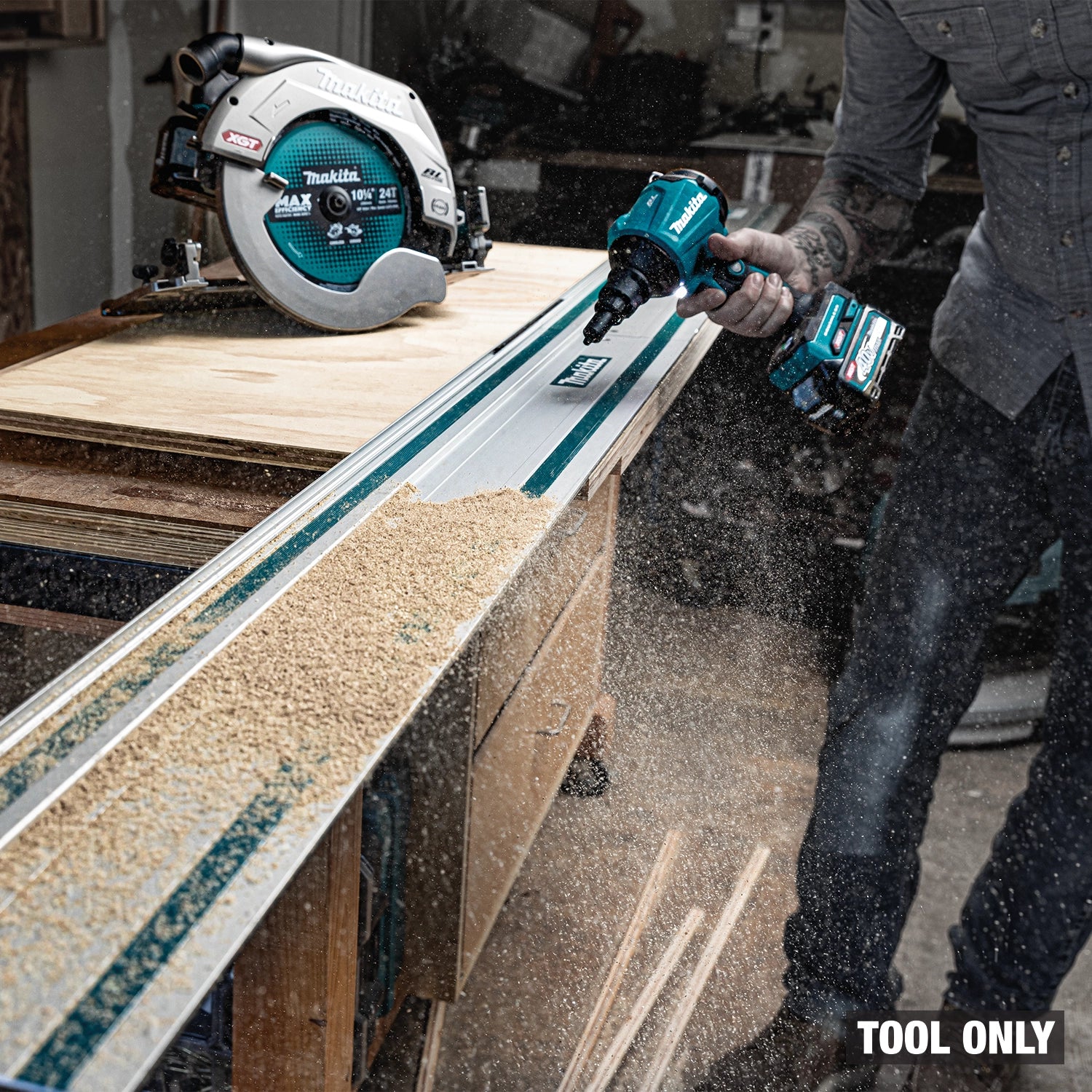 Makita blower pushing sawdust in workshop cleanup
