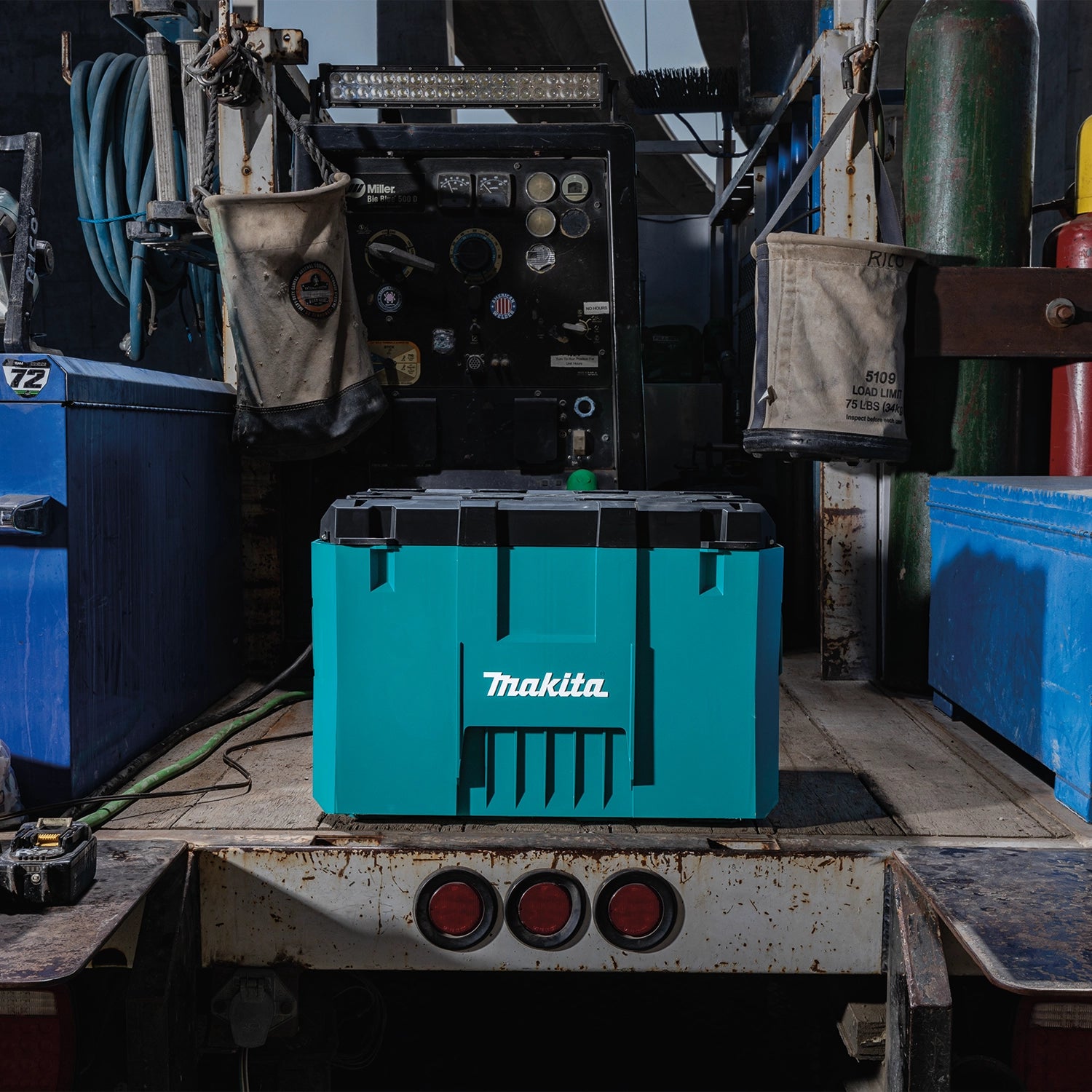 Makita MAKTRAK system shown front-facing while secured in a truck bed
