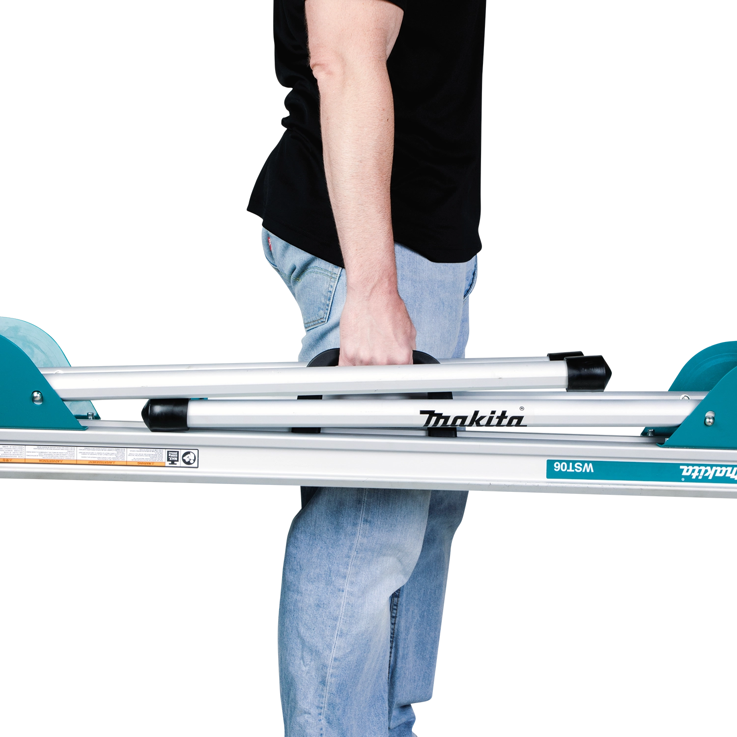 Worker carrying folded Makita miter saw stand
