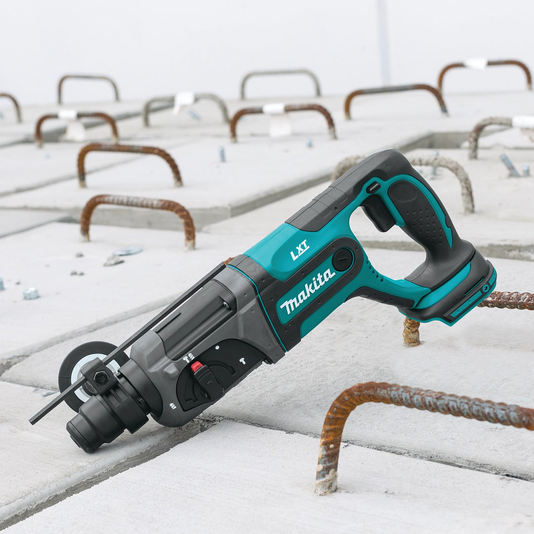Makita SDS-PLUS rotary hammer tipped upward during overhead job site work
