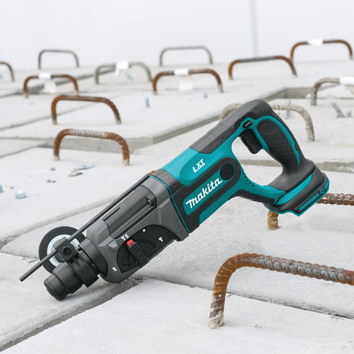 Makita SDS-PLUS rotary hammer tipped upward during overhead job site work
