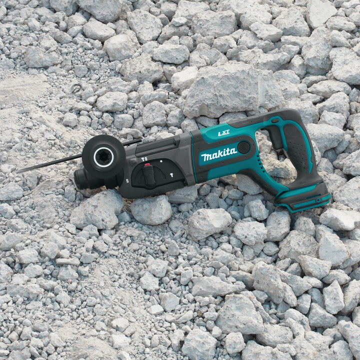 Makita SDS-PLUS rotary hammer in action at job site drilling through concrete

