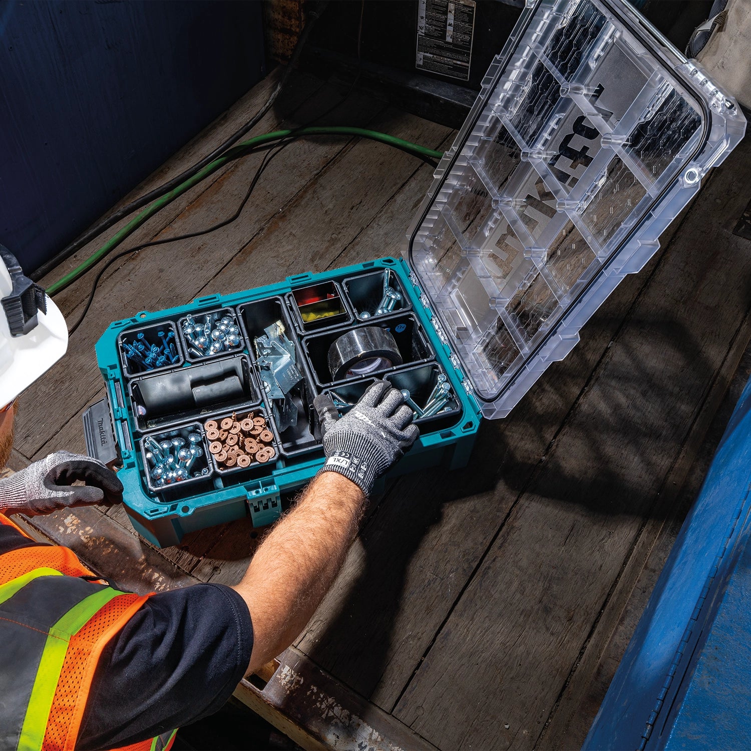 Worker opening Makita T-90043 organizer on jobsite
