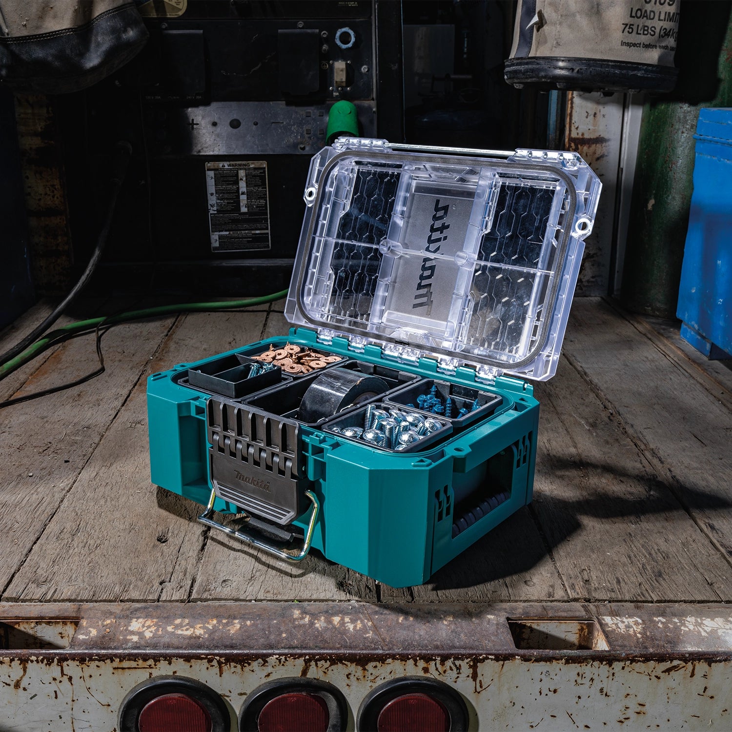 Angled view of Makita T-90065 with open lid showing storage bins
