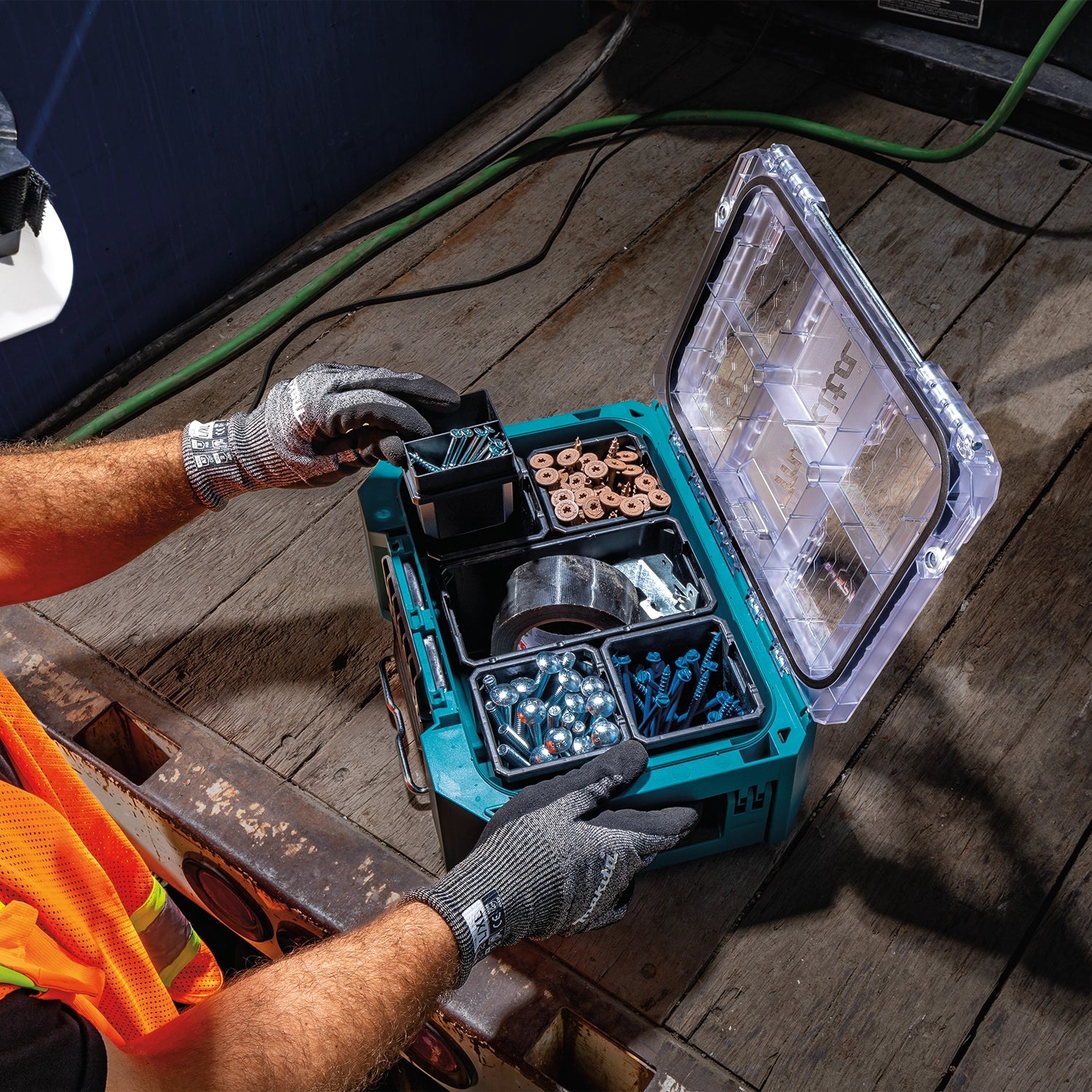 Worker accessing open Makita T-90065 organizer during use
