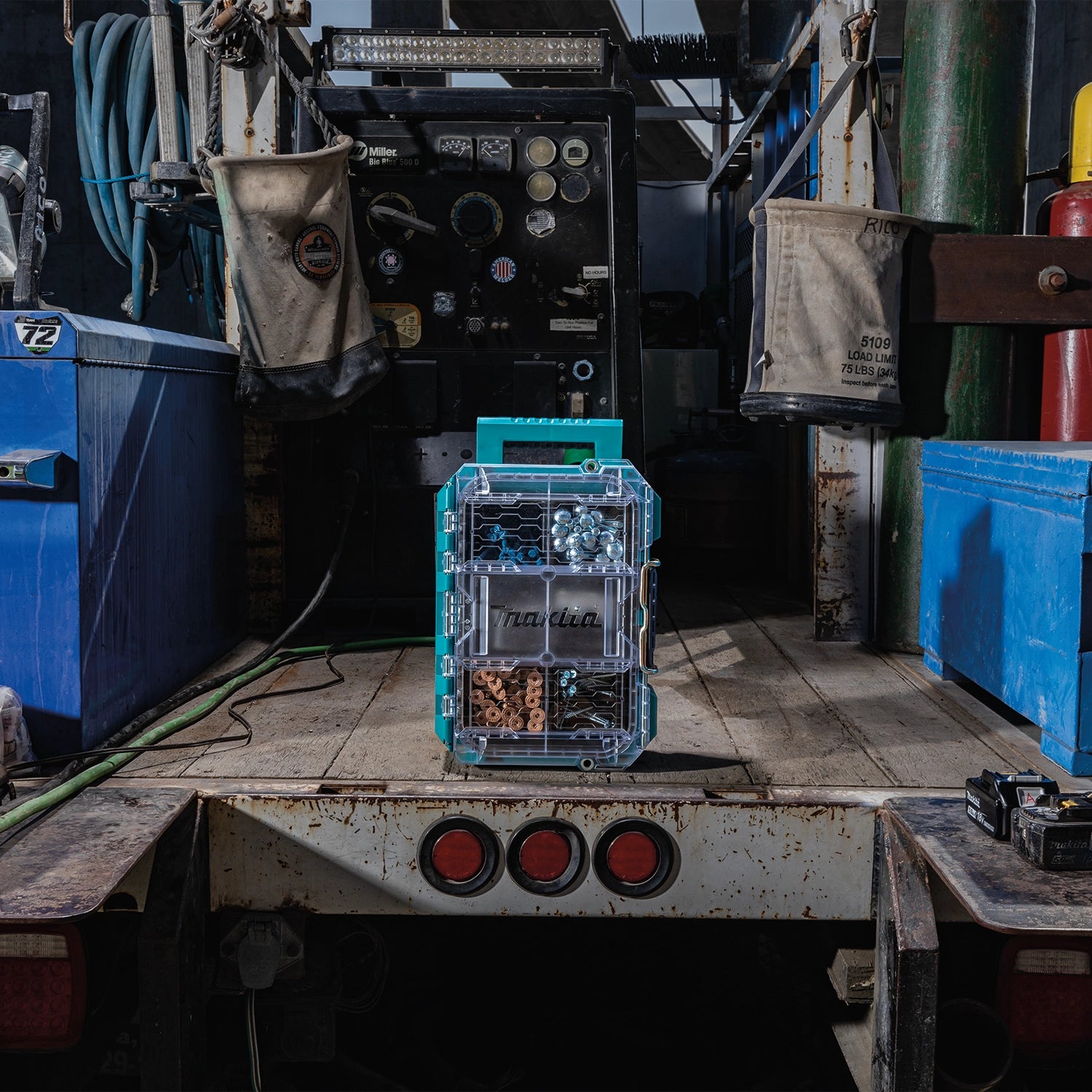 Makita organizer standing upright on truck bed for transport
