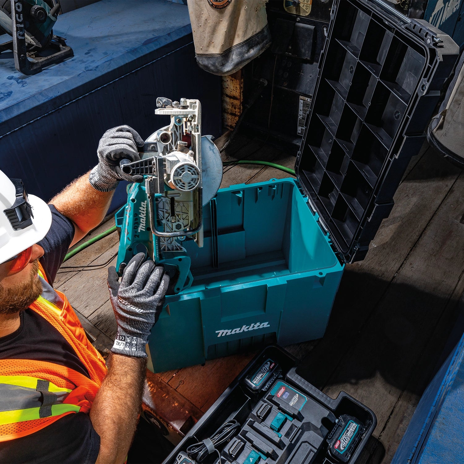 Worker pulling a tool from inside the Makita T-90021 Extra Large Tool Box
