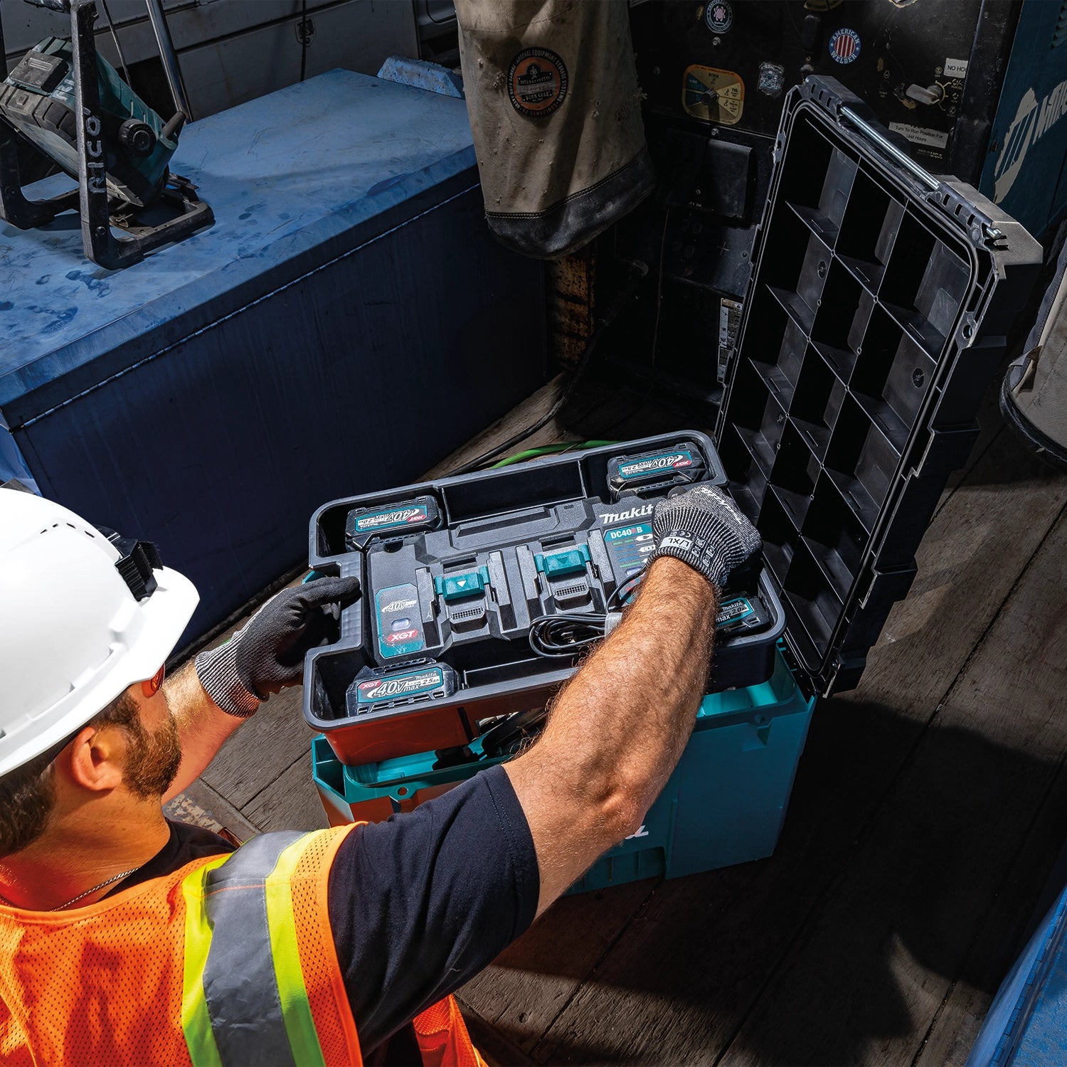 Removable tray being lifted out of Makita T-90021 to access lower storage compartment
