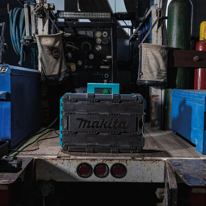 Makita T-90037 Medium Tool Box staged on a truck bed at a jobsite
