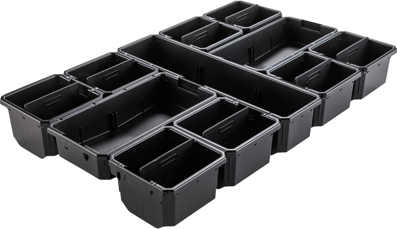 Close-up of 11 removable black bins from the Makita T-90059 Organizer, arranged by size for modular storage

