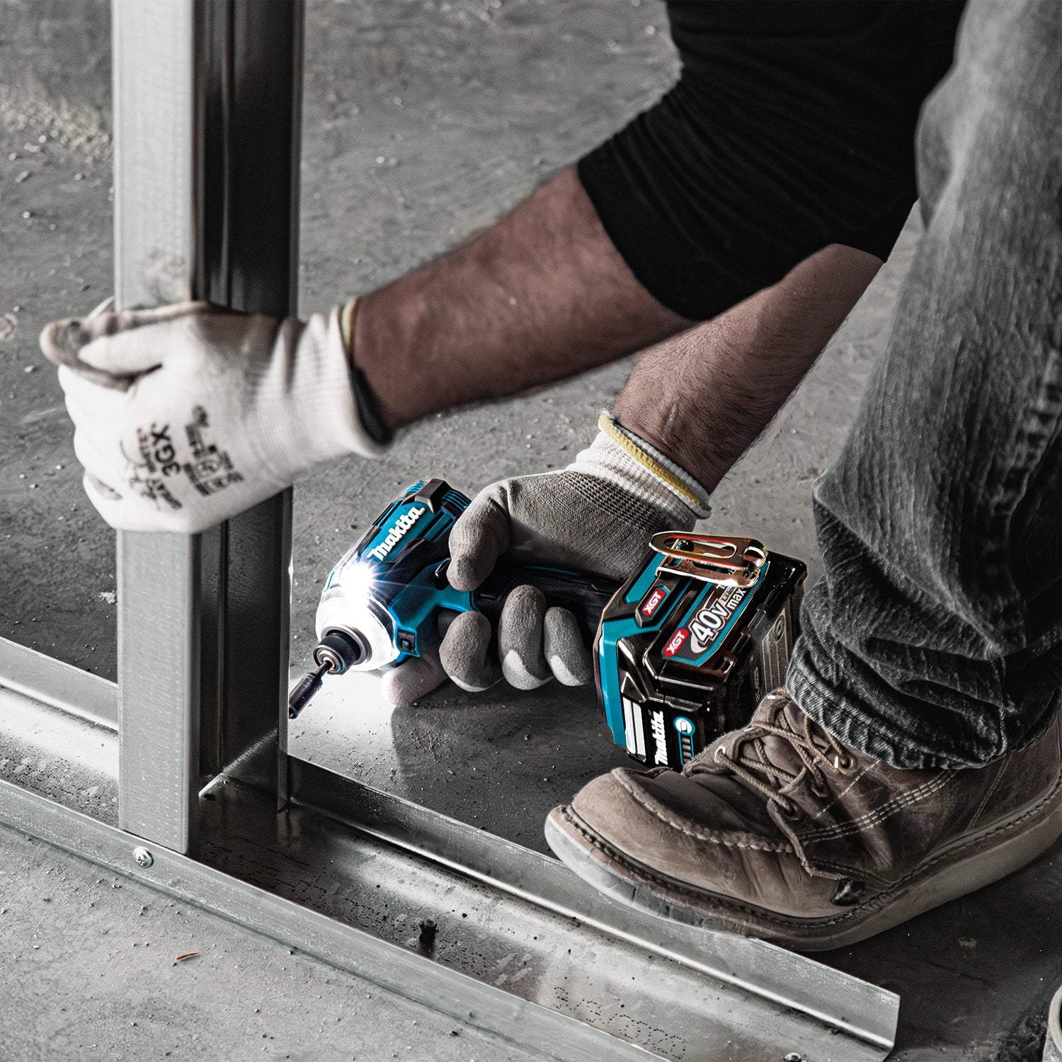 makita drill and impact driver resting on beam during job site break

