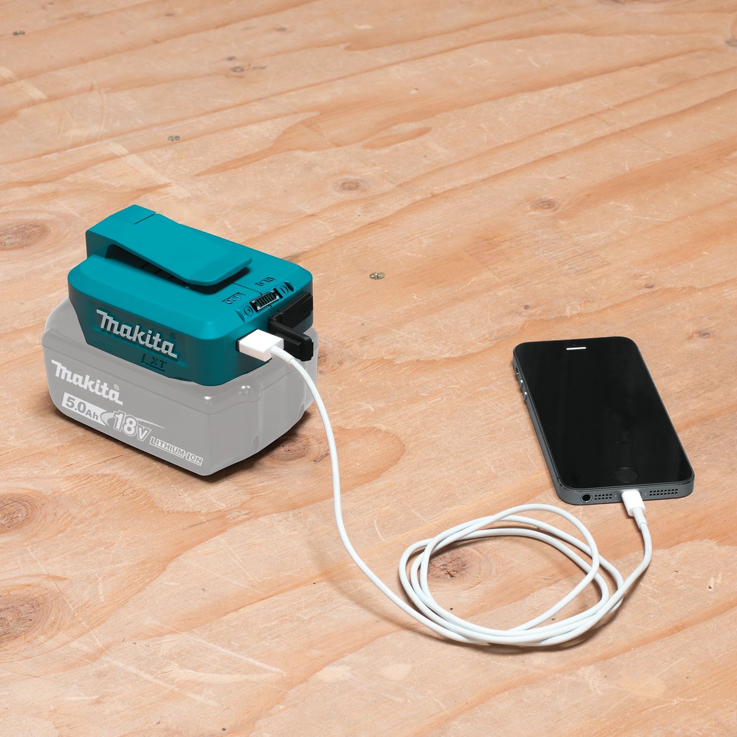 Makita USB adapter plugged into phone and charging
