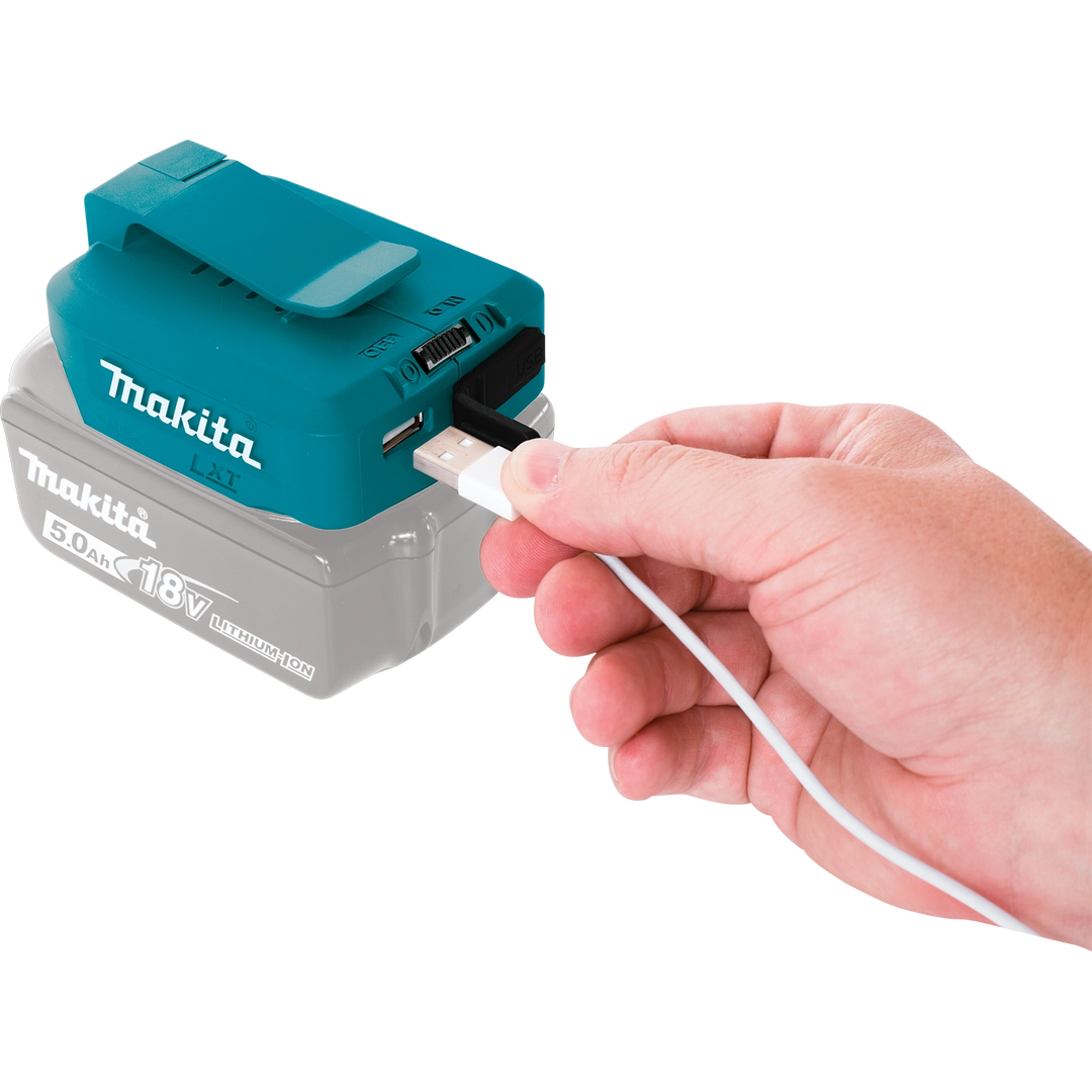 User plugging a phone into the Makita USB power source
