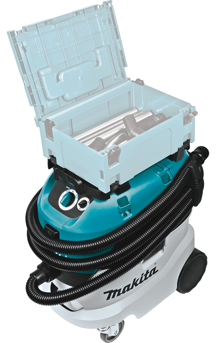 Makita VC4210L vacuum shown with case open, revealing stored hose accessories
