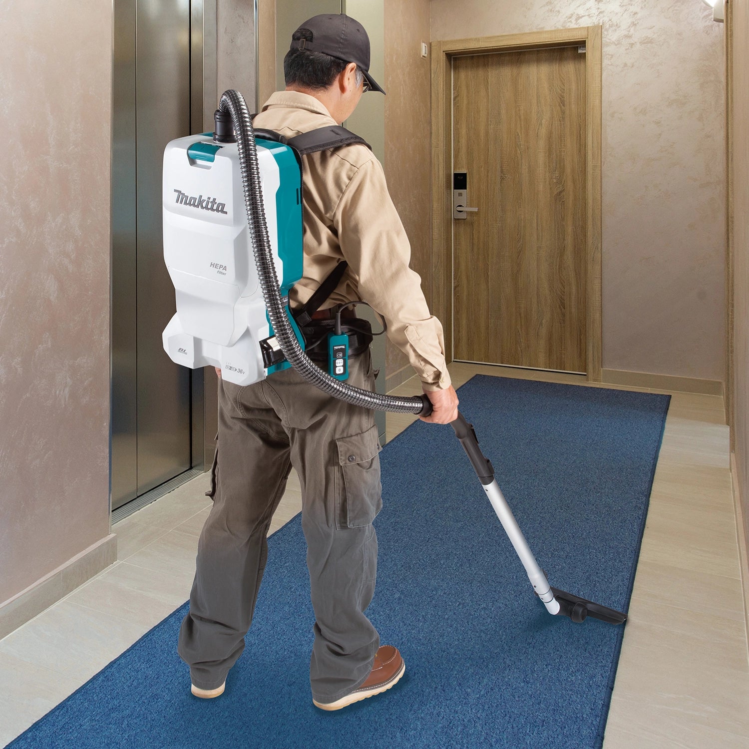 makita backpack vacuum in use collecting drywall dust during renovation
