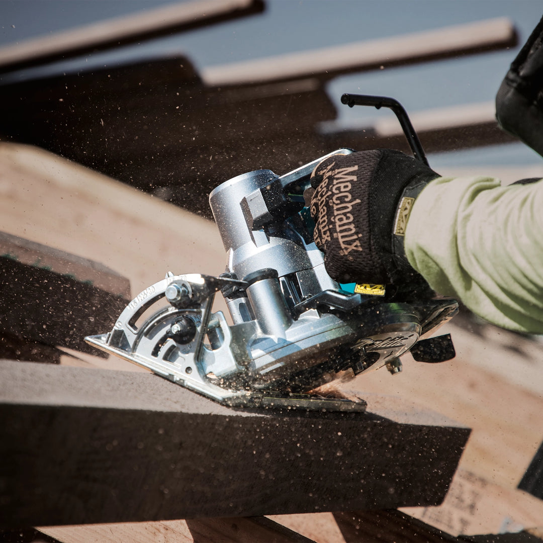 worker using makita xgt saw with dust collection accessory on commercial build

