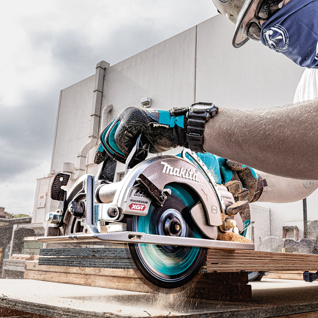 worker using makita 7-1/4 inch xgt saw to cut studs on residential job site
