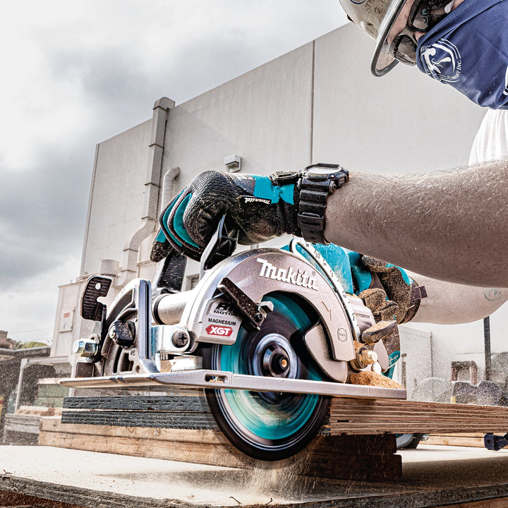 worker using makita 7-1/4 inch xgt saw to cut studs on residential job site
