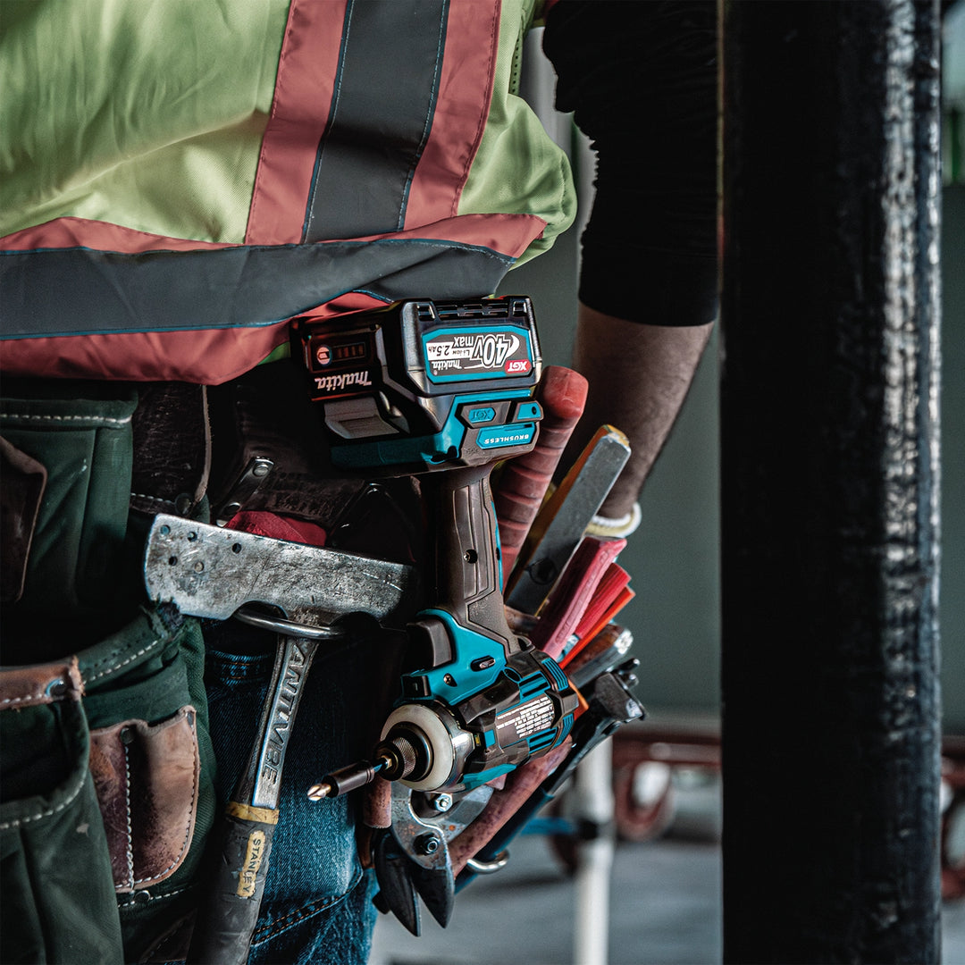 makita xgt combo kit tools on job site drilling through wood beams
