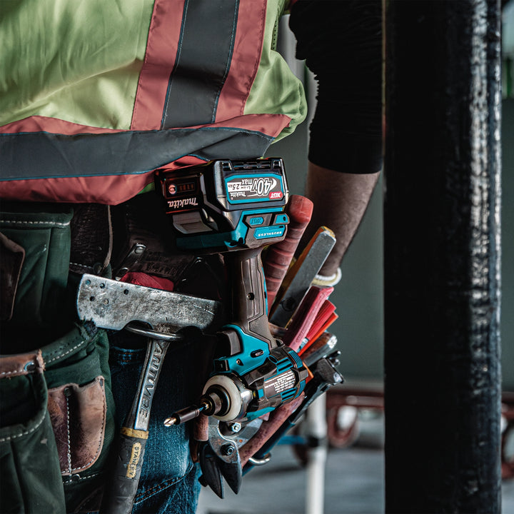 makita xgt combo kit tools on job site drilling through wood beams

