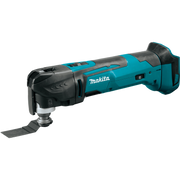 Angled left-side view of Makita XMT03Z multi-tool with ergonomic grip visible
