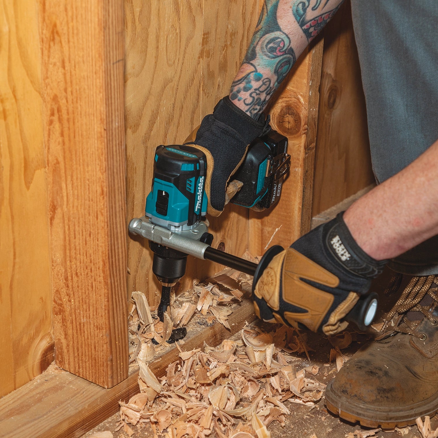 Makita drill used near floor level on construction surface
