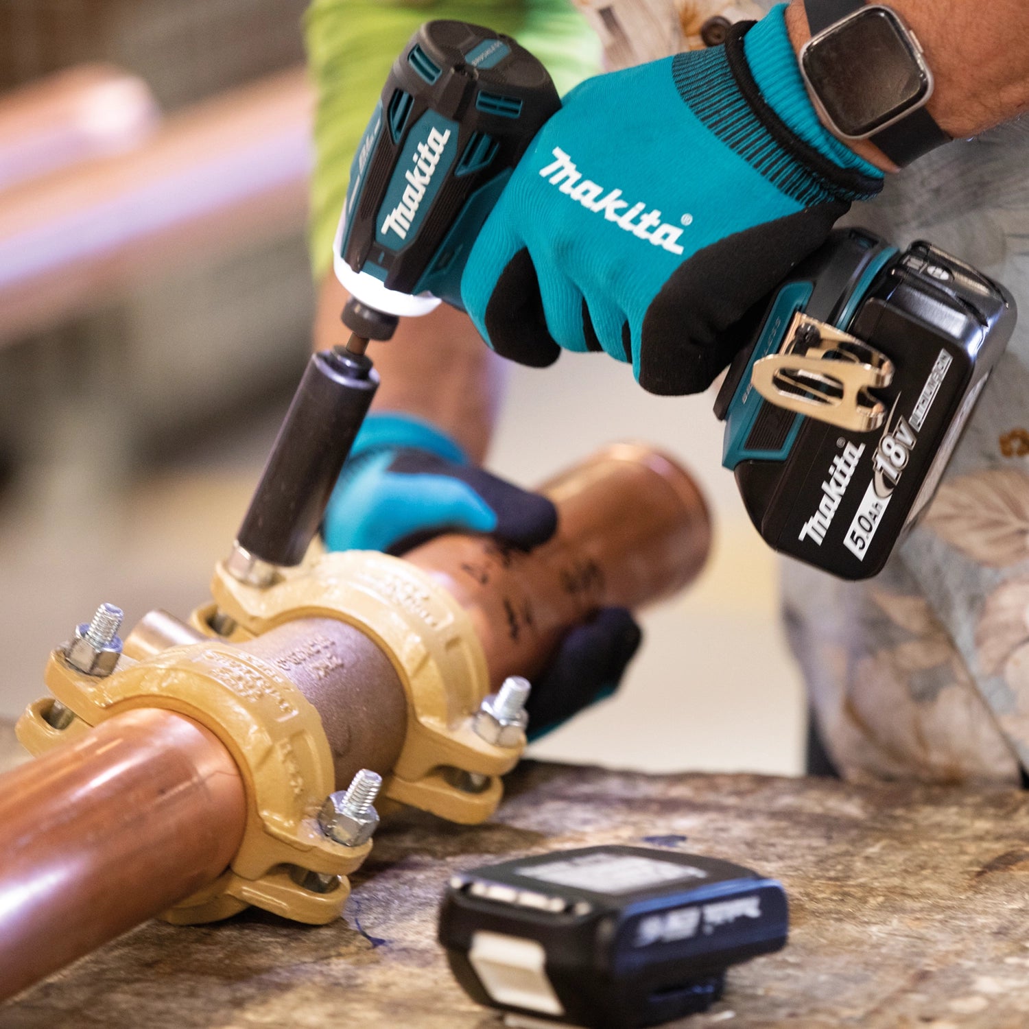Makita XPH14 drill boring through metal pipe on jobsite
