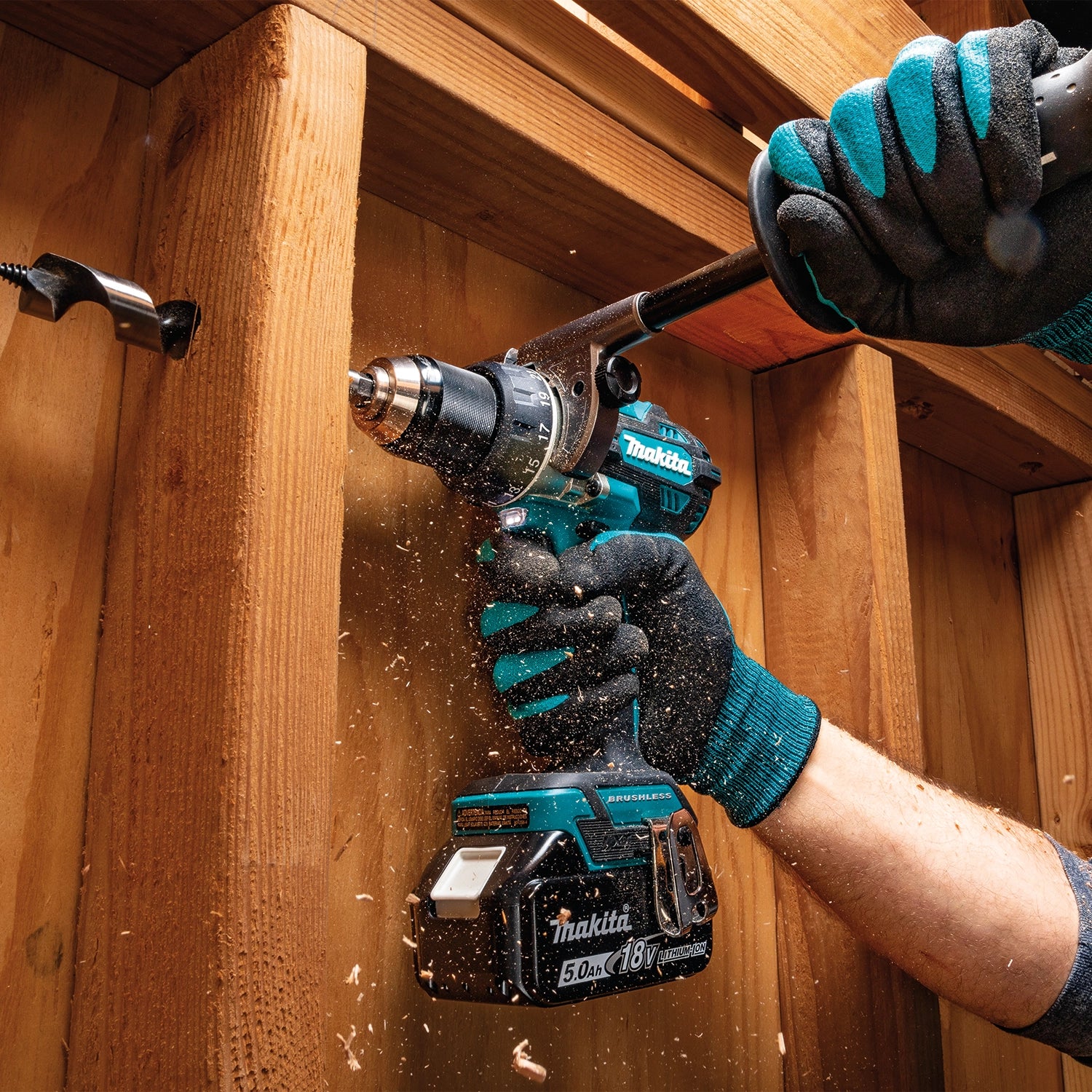 Makita drill shown drilling fully through multiple studs
