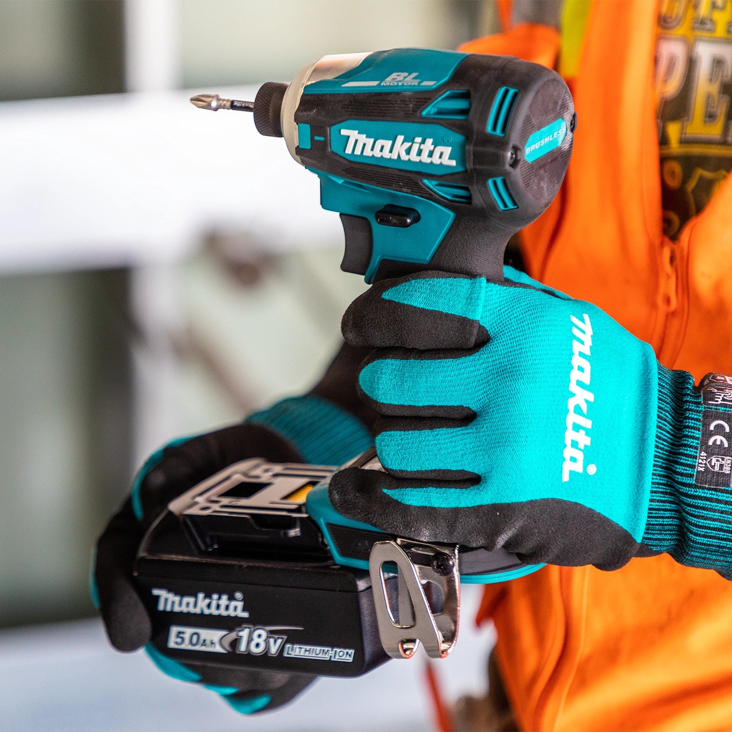 Contractor holding Makita drill with firm ergonomic grip
