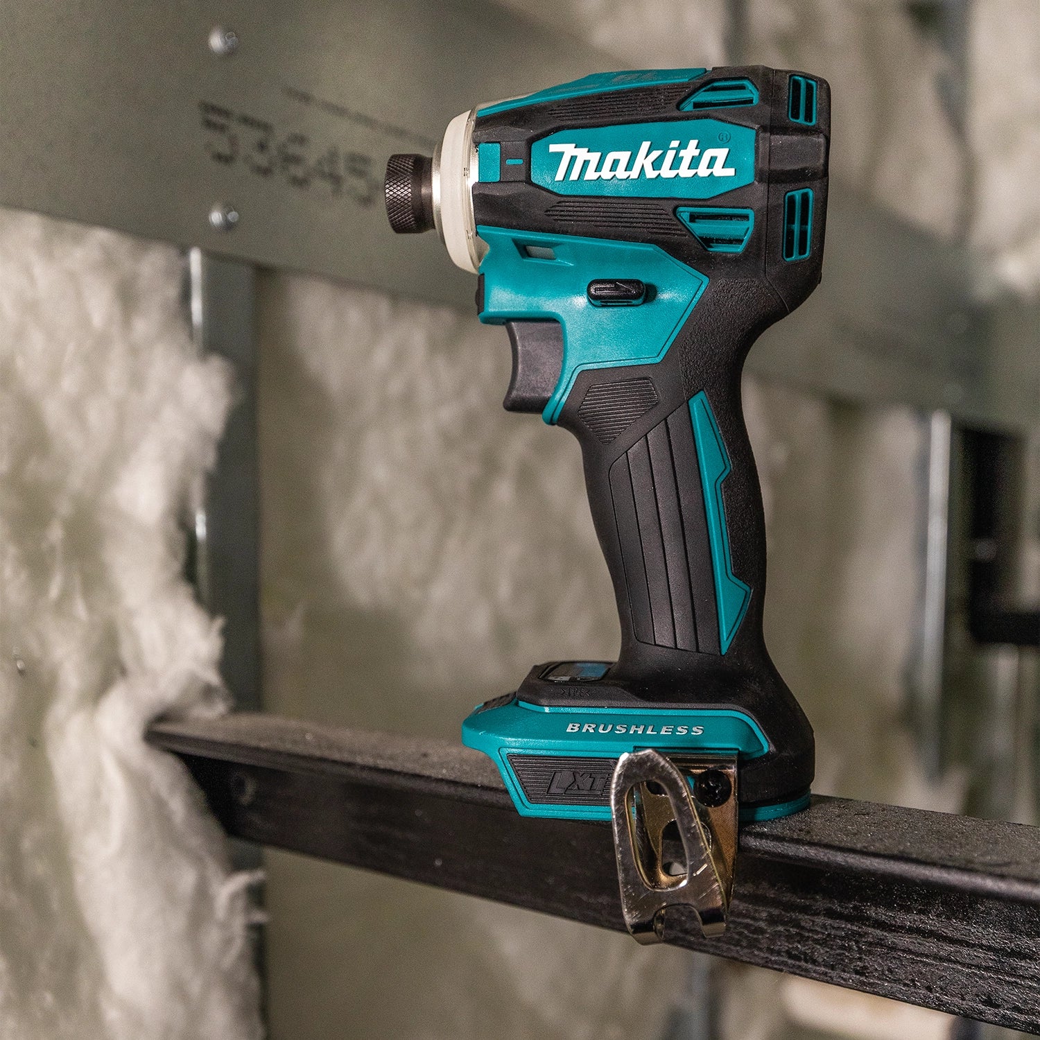 Makita drill operating on wood board for fastener installation
