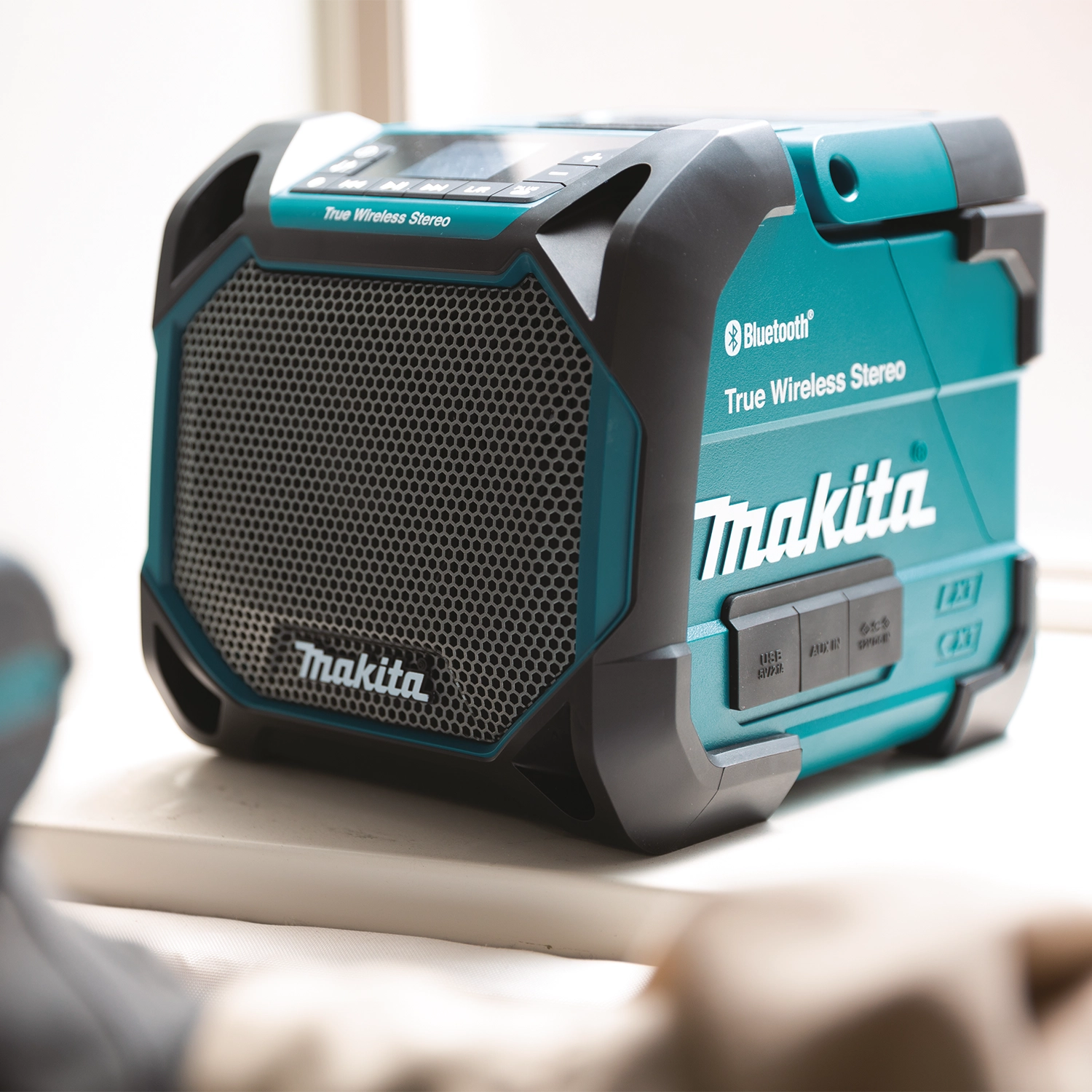 Makita XRM11 displayed on retail shelf with accessories
