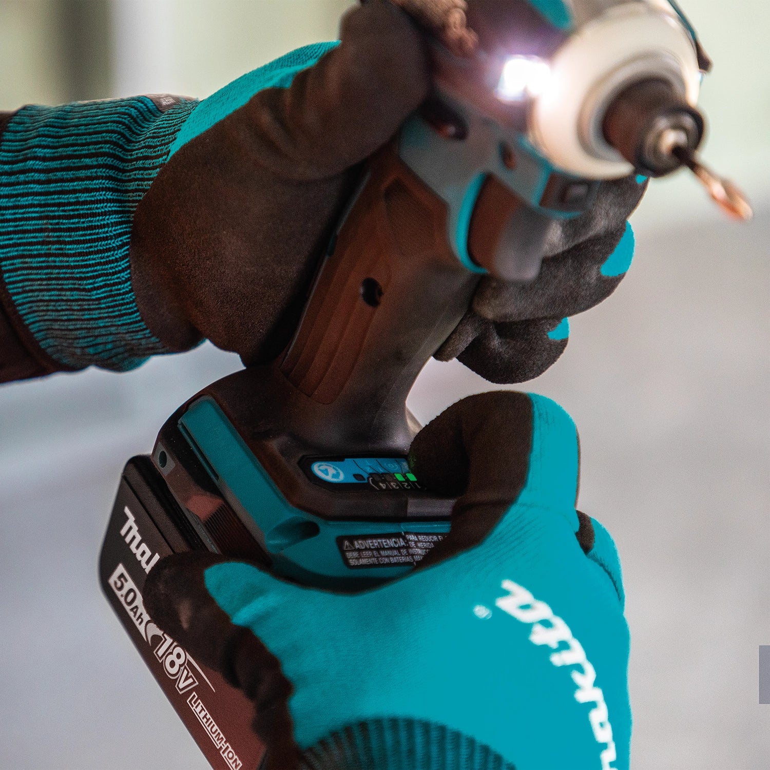 Makita 18V battery being clipped into drill base
